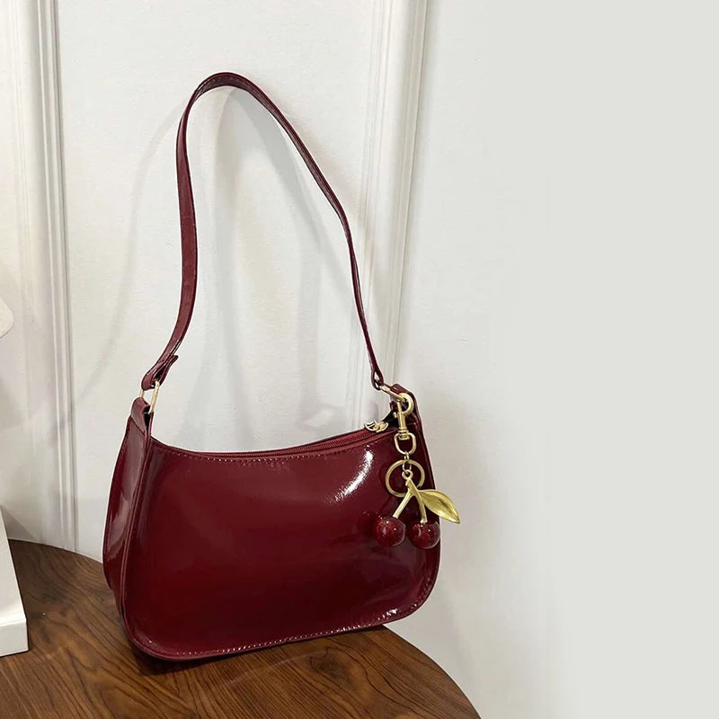 Close-up of a high-quality leather tote bag showing fine stitching and metallic accents.
​