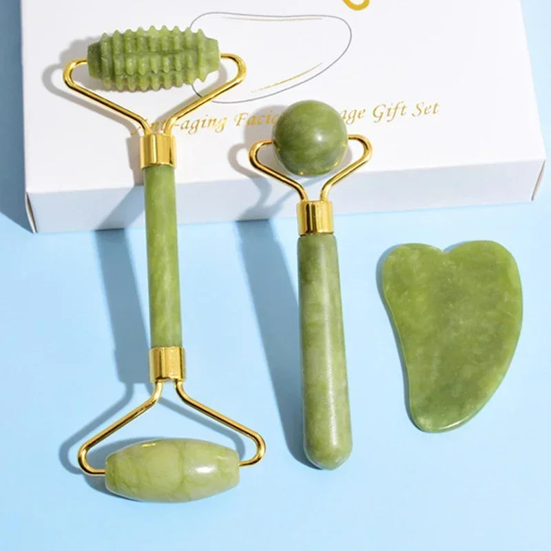 Woman using a green jade roller next to a set of facial massage tools.