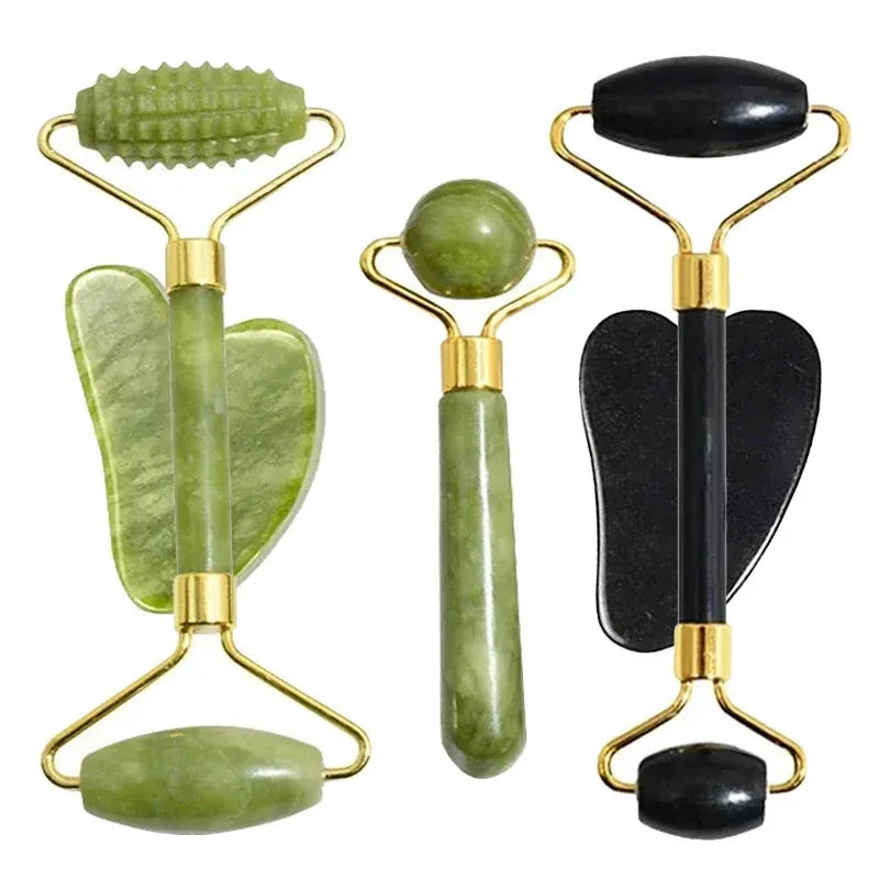 Comparison of light green jade roller and dark obsidian facial roller with gua sha tools.
​