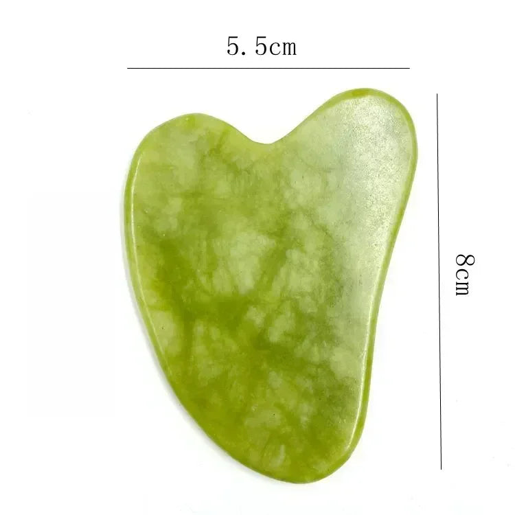 Natural marble-patterned green jade gua sha stone against a white background