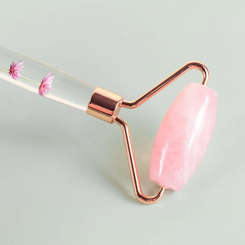 Close-up of a pink quartz facial roller showing the smooth stone and gold frame - Aurora Nova 4