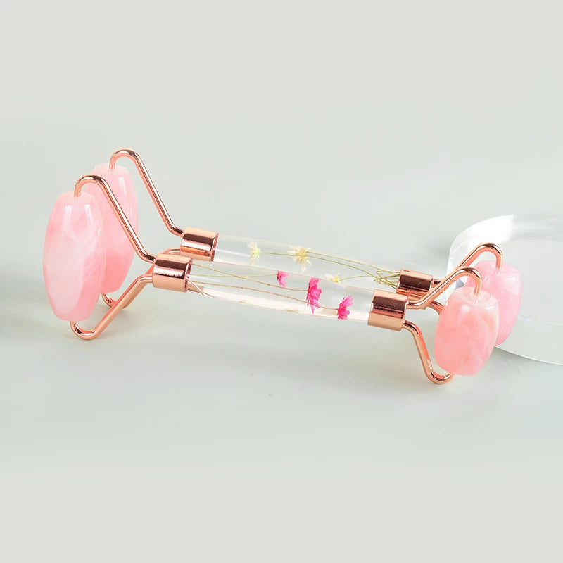 Horizontal view of a pink rose quartz facial roller with transparent handle - Aurora Nova 4